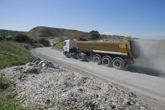 A truck drives by an illegal garbage dump near Alibeykoy Dam on the outskirts of Istanbul, Wednesday, May 19, 2021. Turkey has banned the importation of ethylene polymer plastic waste as environmental groups sound the alarm on the world’s plastic consumption and lack of effective recycling. The Greenpeace Mediterranean group welcomed the news, calling it a “very important step towards the goal of zero waste importation” as set out by Turkey’s Ministry of Environment and Urbanization. (Photo by Mucahit Yapici/AP Photo)