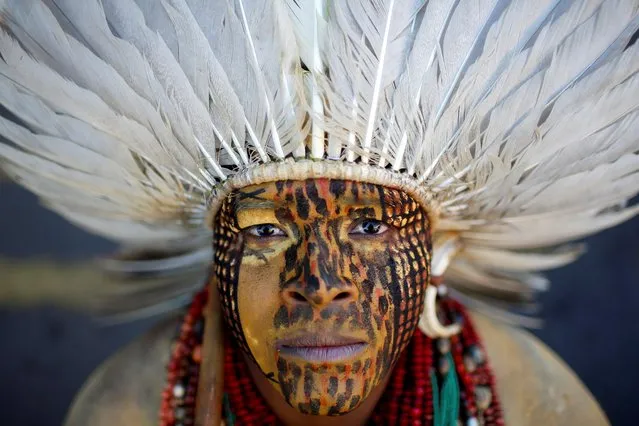 Uinatam Pataxo, of the Pataxo tribe, looks on during a protest for land demarcation and against President Jair Bolsonaro's government, in front of the Planalto Palace in Brasilia, Brazil on June 16, 2021. (Photo by Adriano Machado/Reuters)