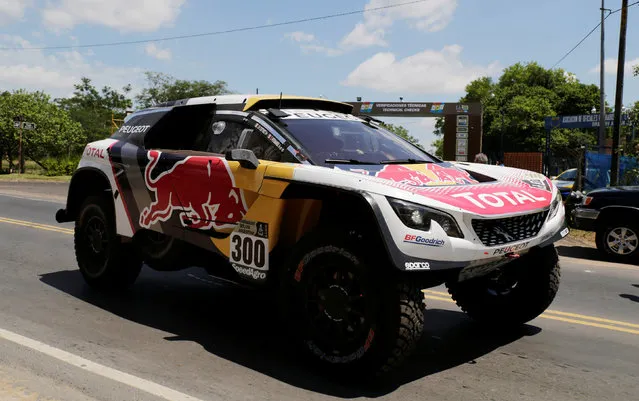 Stephane Peterhansel and co-pilot Jean Paul Cottret drive their Peugeot out to practice after a technical verification check ahead of the Dakar Rally in Luque, Paraguay, December 30, 2016. (Photo by Jorge Adorno/Reuters)