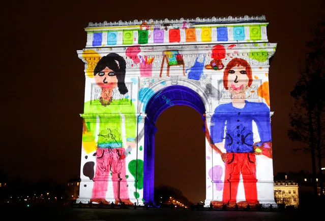 View of a light show on the city's iconic Arc de Triomphe monument during the New Year celebration in Paris, France, December 31, 2016. (Photo by Jacky Naegelen/Reuters)