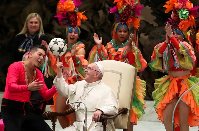 Pope Francis plays with a ball as members of Circus of Cuba perform during the Wednesday general audience in Paul VI Hall at the Vatican January 2, 2019. (Photo by Tony Gentile/Reuters)