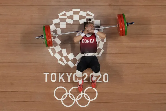 Kim Suhyeon of South Korea drops the barbel as she competes in the women's 76kg weightlifting event, at the 2020 Summer Olympics, Sunday, August 1, 2021, in Tokyo, Japan. (Photo by Luca Bruno/AP Photo)