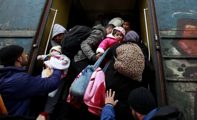 Refugees rush to board a train before its departure towards Serbia, from the transit center for refugees near the southern Macedonia's town of Gevgelija, Sunday, February 14, 2016. Dutch foreign minister Bert Koenders has urged on Sunday some EU member states not to close their borders for migrants, suggesting that “effective border control is most important rather than going to closure”. (Photo by Boris Grdanoski/AP Photo)