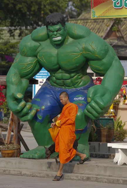 A Buddhist monk walks past a statue of comic character the Hulk at Tamru temple in Samut Prakan province, Thailand, March 3, 2016. It’s a sign of changing times for Buddhism in Thailand when one sees temples, including Wat Tam Ru, using U.S. comic superheroes to attract children and teenagers into the religion. (Photo by Chaiwat Subprasom/Reuters)
