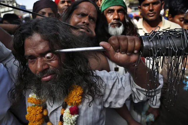 Indian Muslim Sufi devotee use sharp objects to self-flagellate in a procession during the Urs festival at the shrine of Sufi saint Khwaja Moinuddin Chishti in Ajmer, India, Sunday, April 19, 2015. (Photo by Deepak Sharma/AP Photo)