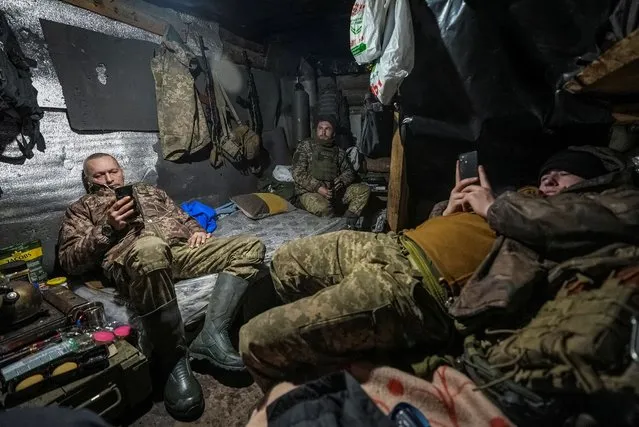 Ukrainian servicemen of 2 battalion 92nd brigade rest inside a dugout, at a position near Bakhmut in Donetsk region, Ukraine on January 10, 2024. (Photo by Inna Varenytsia/Reuters)