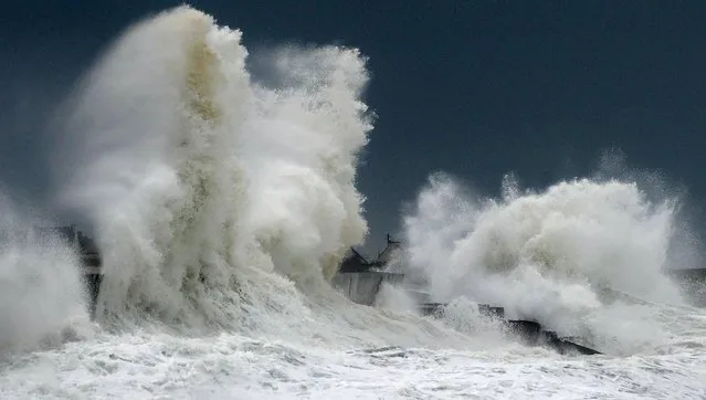 Huges waves break on a harbour wall at the port of Lesconil, western France, on February 3, 2017. Storms will hit the northwest of the country, according to meteorologists. They have also given orange alert for the departments of Finistere, Cotes-d'Armor, Morbihan and Manche with gale force winds and strong waves, with the risk of flooding in some areas. (Photo by Fred Tanneau/AFP Photo)