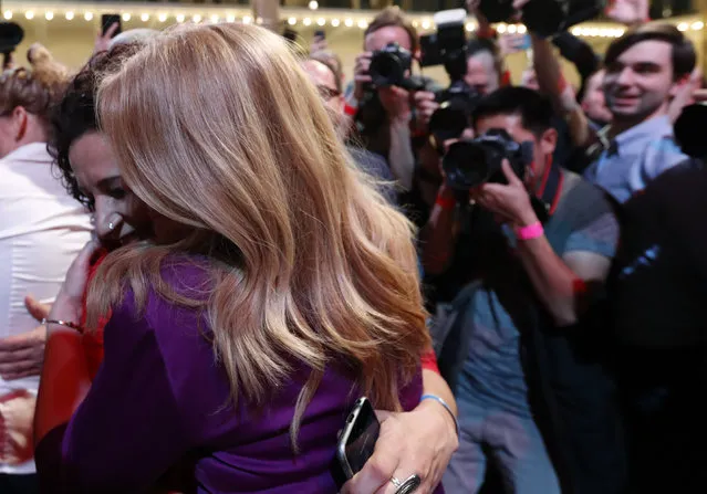 Presidential candidate Zuzana Caputova hugs with a supporter after acknowledging the first preliminary results of the second round of the presidential election in Bratislava, Slovakia, Saturday, March 30, 2019. Voting has ended in the runoff of Slovakia's presidential election, and early results show a favorite female candidate in a lead. (Photo by Petr David Josek/AP Photo)