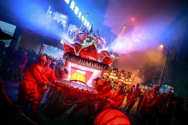 People perform with a long dragon lantern as they celebrate the Chinese Lunar New Year, in Longyan, Fujian province, February 3, 2017. (Photo by Reuters/Stringer)