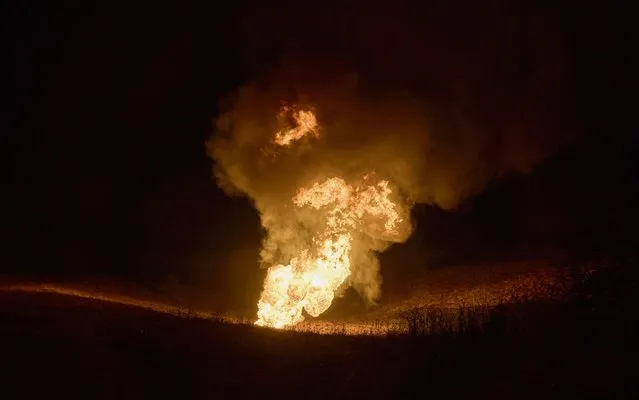 A fire after a rocket hit a gas pipeline on the outskirts of Kharkiv, northeastern Ukraine, 23 January 2024, amid the Russian invasion. At least two persons were killed and four others were injured after a Russian missile strike hit a residential building in Kharkiv overnight, the head of the Kharkiv Regional Military Administration, Oleh Syniehubov wrote on telegram. Russian forces launched air strikes targeting Kiev and Kharkiv on 23 January, Ukrainian authorities said. (Photo by Sergey Kozlov/EPA/EFE)