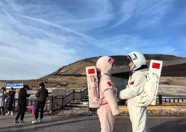 Tourists dressed like astronauts visit Ulan Hada Volcano Geopark on February 13, 2024 in Ulanqab, Inner Mongolia Autonomous Region of China. (Photo by Mao Jianjun/China News Service/VCG via Getty Images)
