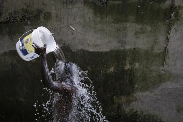 A man takes a bath in Port-au-Prince, Haiti, March 3, 2016. March 22 marks World Water Day. (Photo by Andres Martinez Casares/Reuters)