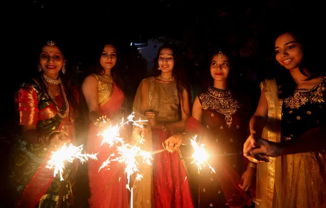 Indian women hold sparklers on the occasion of Diwali, the festival of Lights, in Bhopal, capital of India's Madhya Pradesh, November 3, 2021. The festival of Diwali falls on Nov. 4. (Photo by Xinhua News Agency/Rex Features/Shutterstock)
