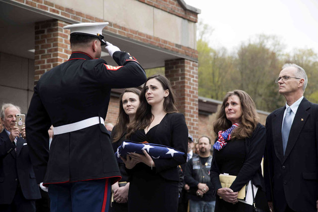 Beth Regan is presented with the flag that draped the casket of her friend Marine Private First Class Robert Graham on Friday, April 26, 2019 in Shrub Oak, NY. Graham, who died at 97 has no living family members but Regan arranged for hundreds to attend his funeral. “Receiving the flag was like receiving a part of him”, Regan said. (Photo by Allyse PulliamAP Photo)
