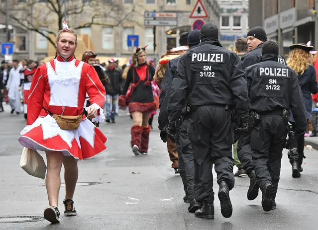 Police patrols when tens of thousands revelers dressed in carnival costumes celebrate the start of the street-carnival in  Cologne, Germany, Thursday, February 23, 2017. (Photo by Martin Meissner/AP Photo)