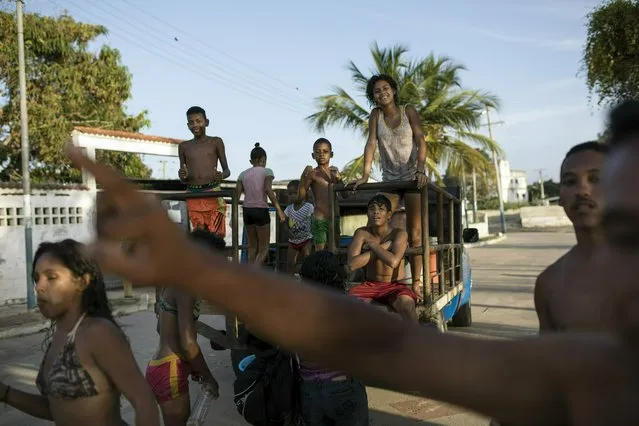 Residents return home after a day at the beach in Machurucuto, Venezuela, Sunday, May 5, 2019. (Photo by Rodrigo Abd/AP Photo)