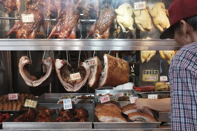 In this Thursday, May 16, 2019, photo, roast pork and poultry meat are displayed for sell at a local market in Hong Kong. A case of African swine fever has been detected in a Hong Kong slaughterhouse, prompting the culling of all 6,000 pigs at the facility. Secretary for Food and Health Sophia Chan said in a statement Friday that the incurable virus was found in a single pig imported from a farm in Guangdong province in mainland China, where the monthslong outbreak has devastated herds. (Photo by Kin Cheung/AP Photo)