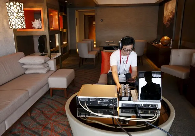 An invited guest enjoys a private listening experience of a test unit of the Sennheiser HE 1 sound system, which is expected to retail for about S$77370 ($55000), in a hotel suite during the CanJam headphone and personal audio expo in Singapore February 21, 2016. (Photo by Edgar Su/Reuters)