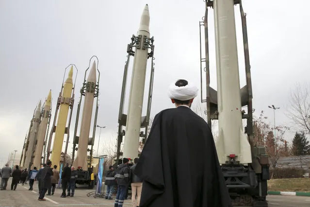 In this February 3, 2019 file photo, an Iranian clergyman looks at domestically built surface to surface missiles displayed by the Revolutionary Guard in a military show marking the 40th anniversary of the Islamic Revolution, at Imam Khomeini Grand Mosque in Tehran, Iran. On Monday, April 8, 2019, the Trump administration designated Iran’s Revolutionary Guard a “foreign terrorist organization” in an unprecedented move against a national armed force. Iran’s Revolutionary Guard Corps went from being a domestic security force with origins in the 1979 Islamic Revolution to a transnational fighting force. (Photo by Vahid Salemi/AP Photo/File)