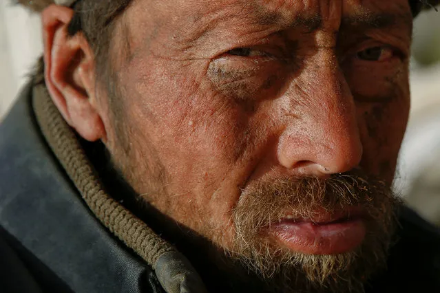 An ethnic Uighur man looks on at the cemetery surrounding the tomb of Imam Asim in the Taklamakan Desert outside the village of Jiya near Hotan, Xinjiang Uighur Autonomous Region, China, March 21, 2017. (Photo by Thomas Peter/Reuters)