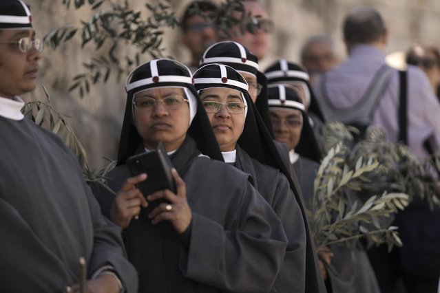 Nuns take part in the Palm Sunday procession on the Mount of Olives in east Jerusalem, Sunday, April 2, 2023. The procession observes Jesus' entrance into Jerusalem in the time leading up to his crucifixion, which Christians mark on Good Friday. (Photo by Mahmoud Illean/AP Photo)