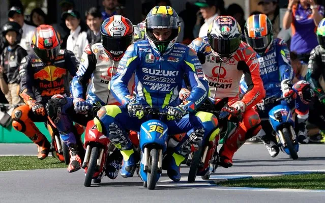 Spanish MotoGP rider Joan Mir (R) of Team Suzuki Ecstar and other MotoGP racers ride mini electric motorcycles at a fan event at Twin Ring Motegi in Motegi, Japan, 17 October 2019. The event was held ahead of the MotoGP race of Japan's Motorcycling Grand Prix scheduled for 20 October 2019. (Photo by Toru Hanai/EPA/EFE)