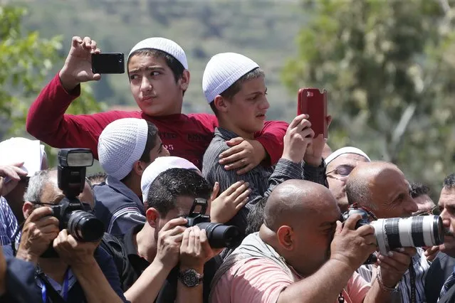 Druz residents take pictures beside photojournalists in a celebration to solidify the reconciliation between Christians and Druze in Brih May 17, 2014. (Photo by Mohamed Azakir/Reuters)