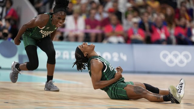 Ezinne Kalu (23), and Promise Amukamara (10), of Nigeria, celebrate in a women's basketball game against Canada at the 2024 Summer Olympics, Sunday, August 4, 2024, in Villeneuve-d'Ascq, France. (Photo by Mark J. Terrill/AP Photo)