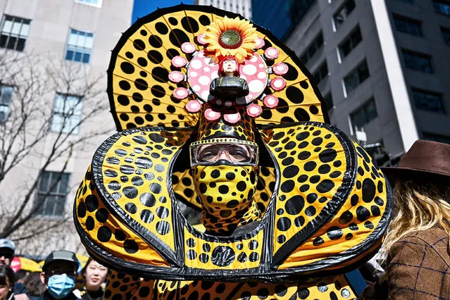 Davey Mitchell, from New York, wearing a Kusama inspired costume poses at the annual Easter Parade and Bonnet Festival along Fifth Avenue on Easter Sunday on April 17, 2022 in New York City. The annual Easter Parade and Bonnet Festival returned this year after being canceled in 2020 and officially held virtually in 2021, although people filled the streets and participated anyway. (Photo by Alexi Rosenfeld/Getty Images)