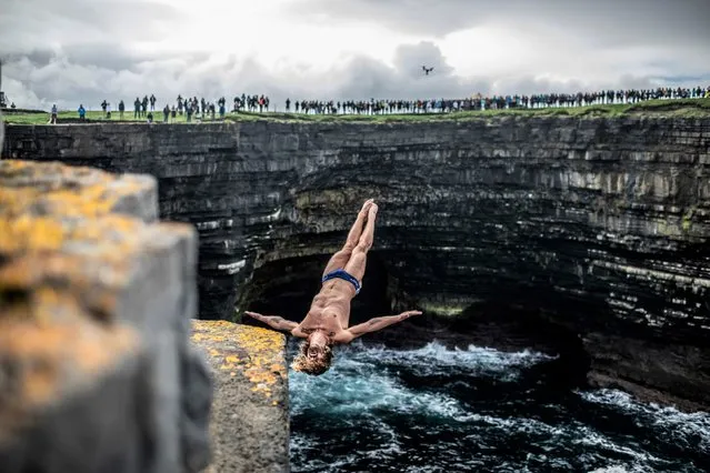In this handout image provided by Red Bull, David Colturi of the USA dives from the 27.5 metre rock platform during the first competition day of the fourth stop of the Red Bull Cliff Diving World Series on September 11, 2021 at Downpatrick Head, Ireland. (Photo by Dean Treml/Red Bull via Getty Images)