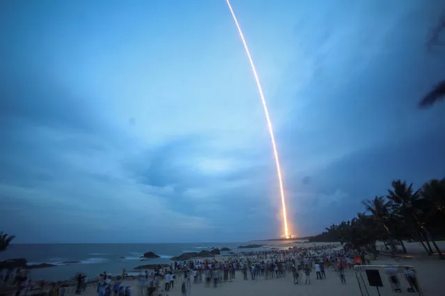 People watch the launch of the Long March-5 Y2 rocket from Wenchang Satellite Launch Center in Wenchang, Hainan Province, China, July 2, 2017. (Photo by Reuters/Stringer)