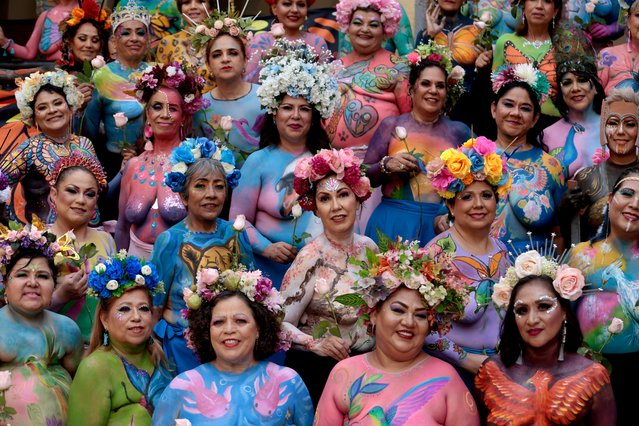 Breast cancer survivors pose for a photograph during the ninth edition of the project “Una pincelada por la vida” (A brushstroke for life), in Zapopan, Jalisco state Mexico, on September 8, 2024. “Una pincelada por la vida” is an altruistic project involving more than 100 women survivors with the aim to raise awareness of breast cancer in the world. (Photo by Ulises Ruiz/AFP Photo)