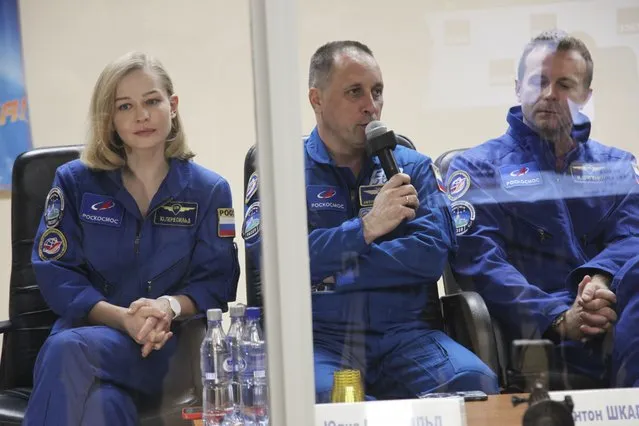 In this handout photo released by Roscosmos, actress Yulia Peresild, left, director Klim Shipenko, right, and cosmonaut Anton Shkaplerov, members of the prime crew of Soyuz MS-19 spaceship attend a news conference at the Russian launch facility in the Baikonur Cosmodrome, Kazakhstan, Monday, October 4, 2021. In a historic first, Russia is set to launch an actress and a film director to space to make a feature film in orbit. Actress Yulia Peresild and director Klim Shipenko are set to blast off Tuesday for the International Space Station in a Russian Soyuz spacecraft together with Anton Shkaplerov, a veteran of three space missions.(Photo by Roscosmos Space Agency via AP Photo)