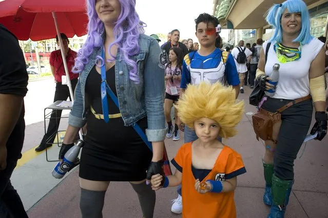 Scarlett Lewis, 4, who is dressed as the Dragon Ball character Goku walks with her family outside the San Diego Convention Center during the preview night for Comic Con 2017 in San Diego, California, USA, 19 July 2017. The Comic Con runs from 20 to 23 July. (Photo by David Maung/EPA)