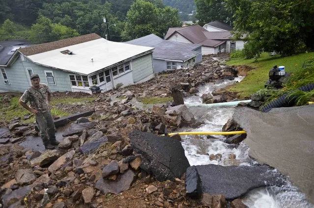 Rob Morissin stands among the aftermath of a rockslide caused by severe flooding that poured into a property owned by his family since the 1930's in Richwood, W.Va. on Friday June 24, 2016. (Photo by Christian Tyler Randolph/Charleston Gazette-Mail via AP Photo)