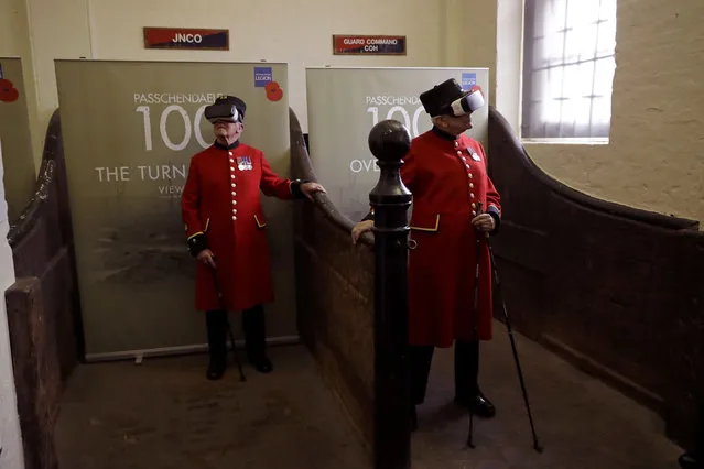 Chelsea pensioners John Kidman, aged 87, right, and Bill “Spud” Hunt, aged 83, pose for photographers by wearing virtual reality headsets during an exhibition launch inside 18th century vaulted stables at the Household Cavalry Museum in London, Tuesday, July 25, 2017. The exhibit uses virtual reality videos, with diary accounts, audio, archive film and photos to commemorate the 100-year anniversary of the Battle of Passchendaele in World War I, which saw an estimated total of 550,000 soldiers killed from both sides. (Photo by Matt Dunham/AP Photo)