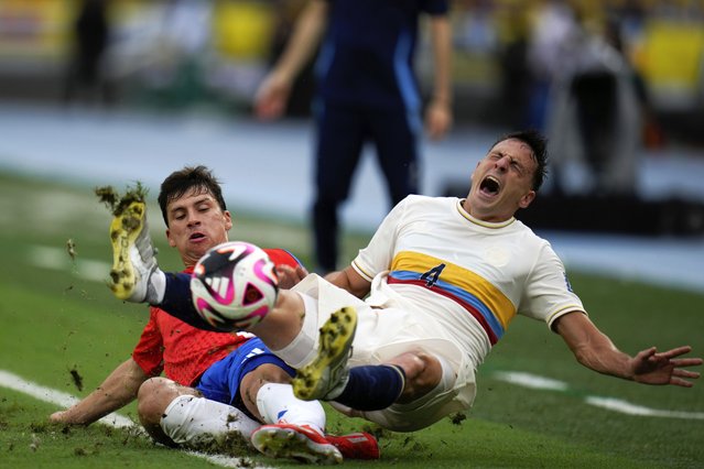 Colombia's Santiago Arias, right, and Chile's Gonzalo Tapia fall during a FIFA World Cup 2026 qualifying soccer match at the Metropolitano Roberto Melendez stadium in Barranquilla, Colombia, October 15, 2024. (Photo by Fernando Vergara/AP Photo)