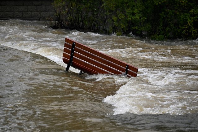 A view shows a partially submerged bench, following heavy rainfalls in Litovel, Czech Republic on September 16, 2024. (Photo by Radovan Stoklasa/Reuters)