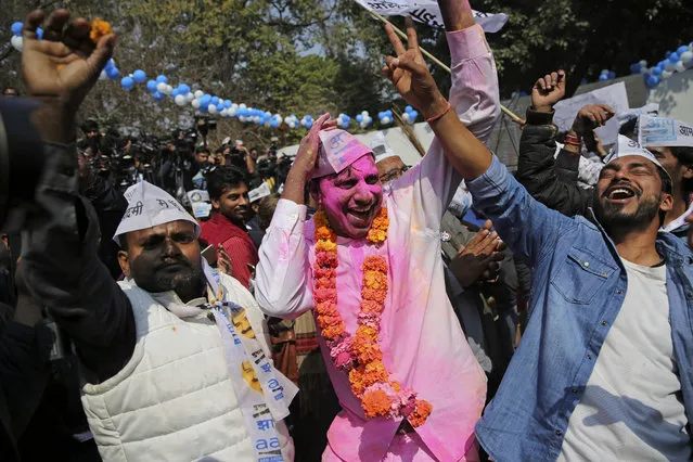 Supporters of the Aam Aadmi Party, or “common man's” party, celebrate the party's victory, at their party office in New Delhi, India, Tuesday, February 11, 2020. Indian Prime Minister Narendra Modi's Hindu nationalist party was facing a major defeat by the regional party Tuesday in elections in the national capital that were seen as a referendum on Modi's policies such as a new national citizenship law that excludes Muslims. (Photo by Altaf Qadri/AP Photo)
