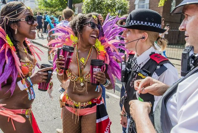 Police help Dancers with a plaster as they prepare for the parade at Notting Hill Carnival on August 28, 2017 in London, England. (Photo by Guy Bell/Rex Features/Shutterstock)