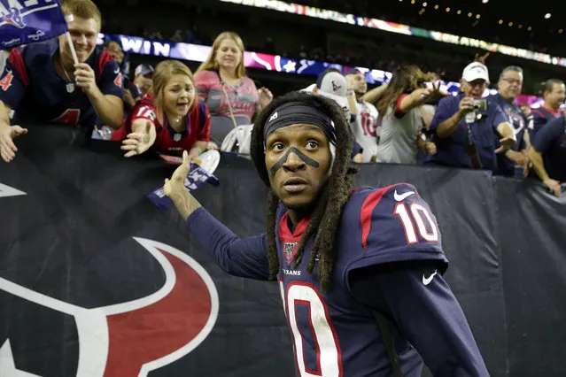 In this January 4, 2020, file photo, Houston Texans wide receiver DeAndre Hopkins celebrates with fans after an NFL wild-card playoff football game against the Buffalo Bills in Houston. The Arizona Cardinals have acquired three-time All-Pro receiver DeAndre Hopkins in a trade that will send running back David Johnson and draft picks to the Houston Texans, a person familiar with the situation told The Associated Press. The person spoke to the AP on condition of anonymity Monday, March 16, 2020, because the trade hasn't been officially announced. (Photo by Michael Wyke/AP Photo)