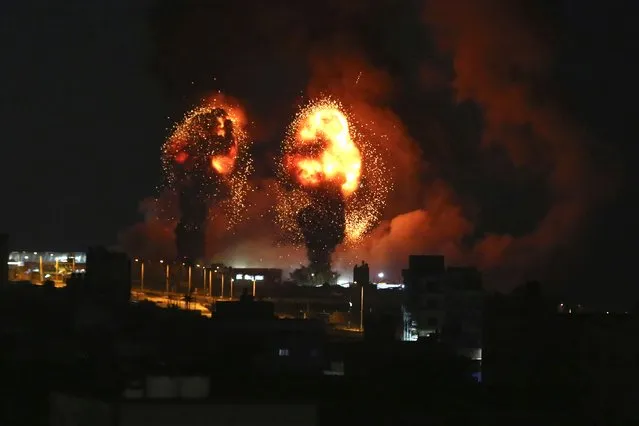 Sparks from an explosion caused by Israeli airstrikes in Gaza City, Saturday, July 16, 2022. (Photo by Mohammed Ali/AP Photo)