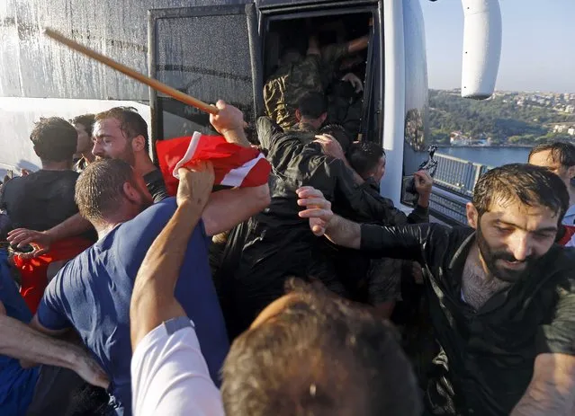 Soldiers push each other to board a bus to escape the mob after troops involved in the coup surrendered on the Bosphorus Bridge in Istanbul, Turkey July 16, 2016. (Photo by Murad Sezer/Reuters)