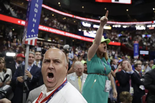 Illinois delegate Christian Gramm, left, and other delegates react as some call for a roll call vote on the adoption of the rules during first day of the Republican National Convention in Cleveland, Monday, July 18, 2016. (Photo by John Locher/AP Photo)
