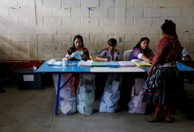 A woman waits to get his finger inked after casting her vote at a polling station during general elections in Guatemala City, September 6, 2015. Still reeling from a corruption scandal that felled their president three days ago, Guatemalans headed to the polls on Sunday to elect a new leader in a tight contest that is likely to head to a second round run-off. (Photo by Jorge Dan Lopez/Reuters)