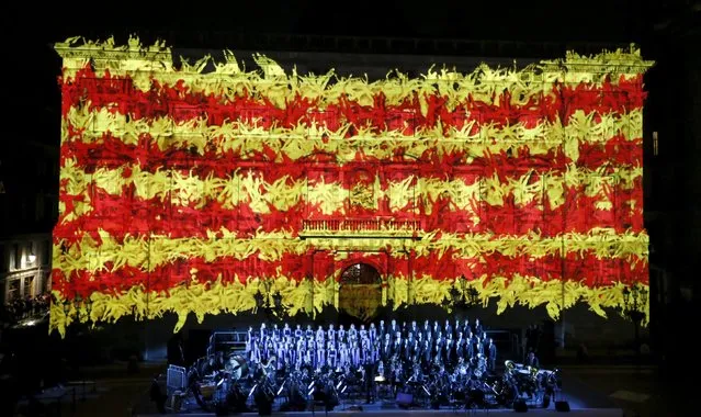 The Catalan flag is seen on the facade of the Palau de la Generalitat during a ceremony to mark “Diada de Catalunya” (Catalunya's National day) on September 11, at Sant Jaume square in central Barcelona September 9, 2015. (Photo by Gustau Nacarino/Reuters)