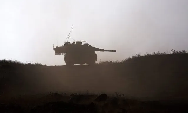 Israeli Merkava tanks from the armored corps during a training  exercise with live ammunition in the center of the Golan Heights, near the Israel border with Syria, 08 August 2016. The training is part of the Israeli army annual training in the Golan Heights. (Photo by Atef Safadi/EPA)