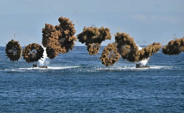 South Korean Marine amphibious assault vehicles fire smoke shells to land on the seashore during a landing operation as part of the annual Hoguk military exercise in Pohang, South Korea on October 26, 2022. (Photo by Jung Yeon-je/Pool via Reuters)