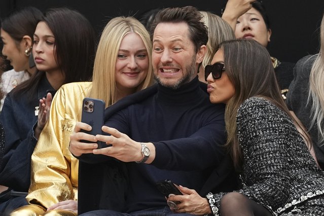 Dakota Fanning, from left, Derek Blasberg, and Jessica Alba attend the Chanel Fall/Winter 2025-2026 Womenswear collection presented Tuesday, March 11, 2025. in Paris. (Photo by Scott A Garfitt/Invision/AP Photo)