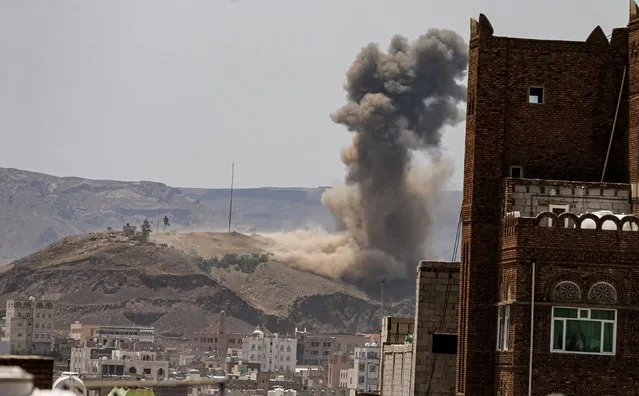 Smoke and dust rise from the site of an air strike on the outskirts of Sanaa, Yemen on July 1, 2020. (Photo by Khaled Abdullah/Reuters)